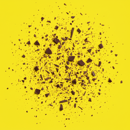 Zartbitter mit Zitrone & Knall Musterpaket B2B - Handgeschöpfte Schokolade auf gelbem Hintergrund.